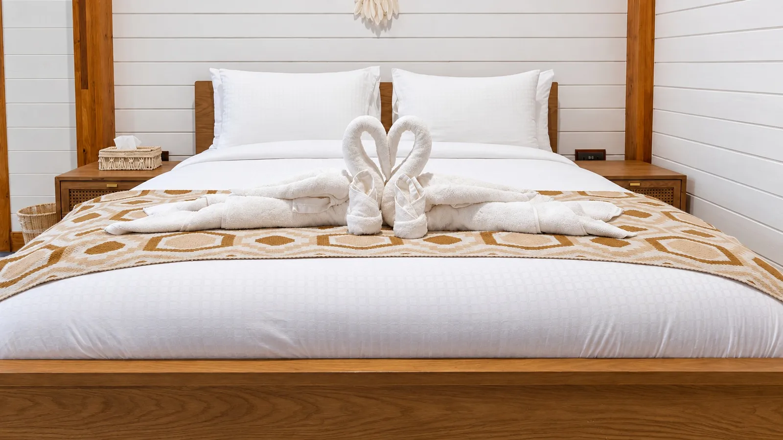 Bed decorated with towel swans — Standard villa, Casa di Legno Resort